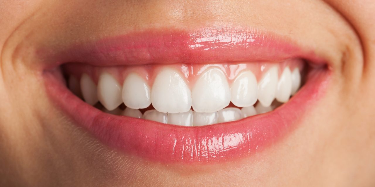 perfect smile with red lips, extreme closeup